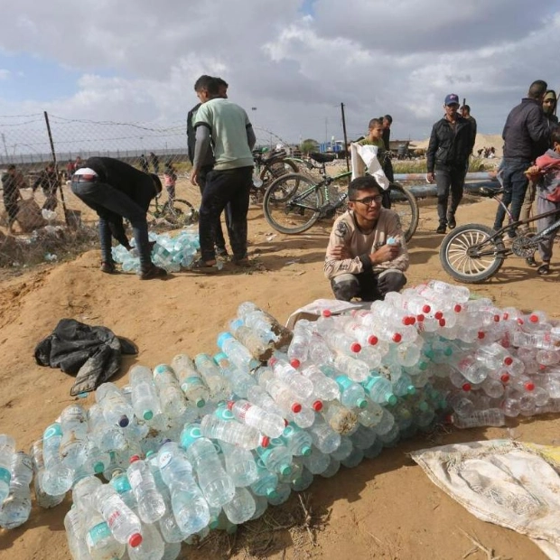 Palestinians Loot and Sell Water from Aid Trucks