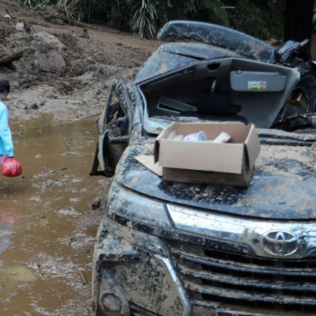 Indonesia Rescuers Dig Through Mud After Landslides Kill 20