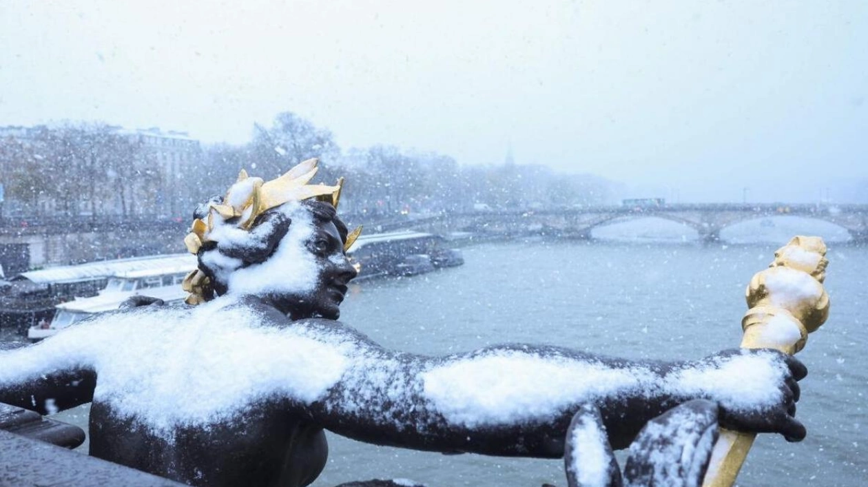 Paris Snowstorm: Alexandre III Bridge Statue in Heavy Snowfall