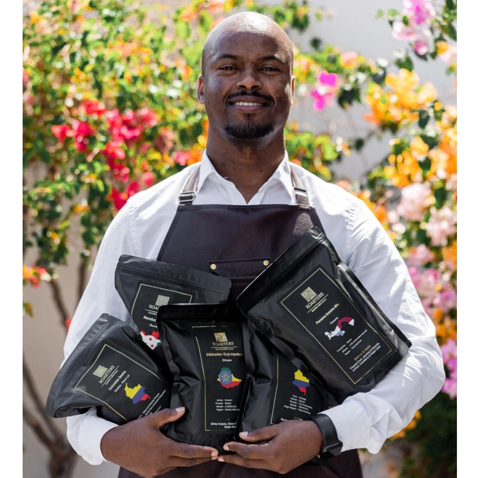 A man with coffee bags in his hands