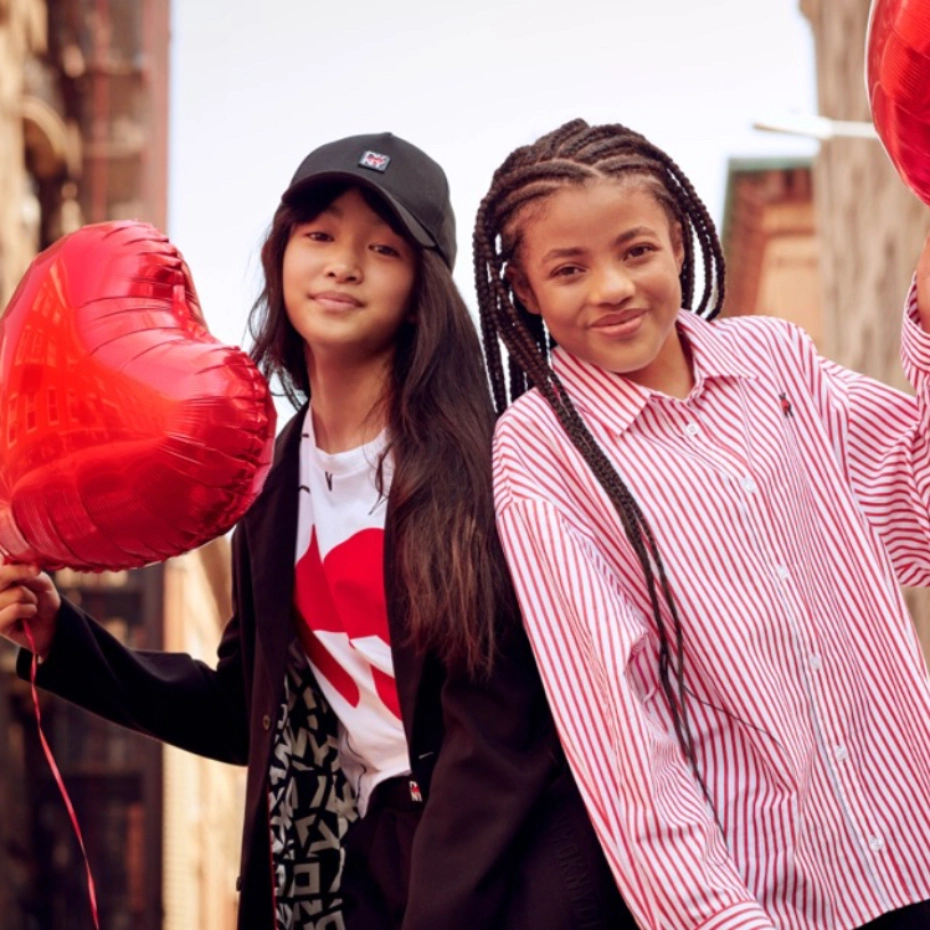 children holding red balloons