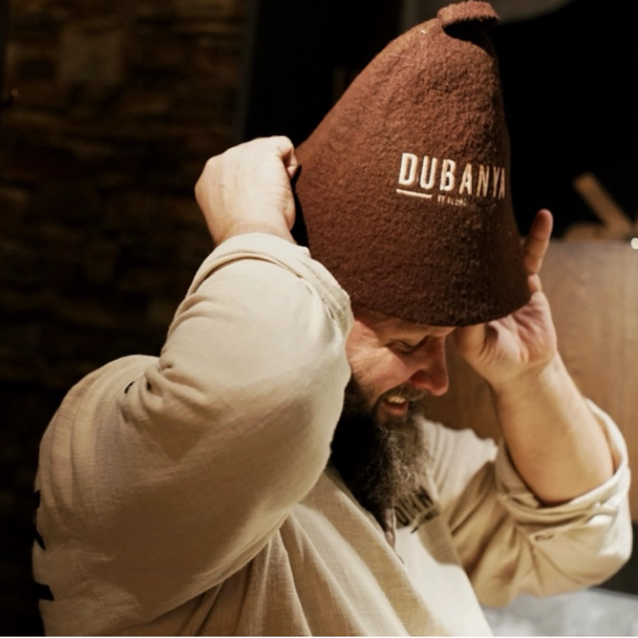 A Russian man putting on a hat for banya